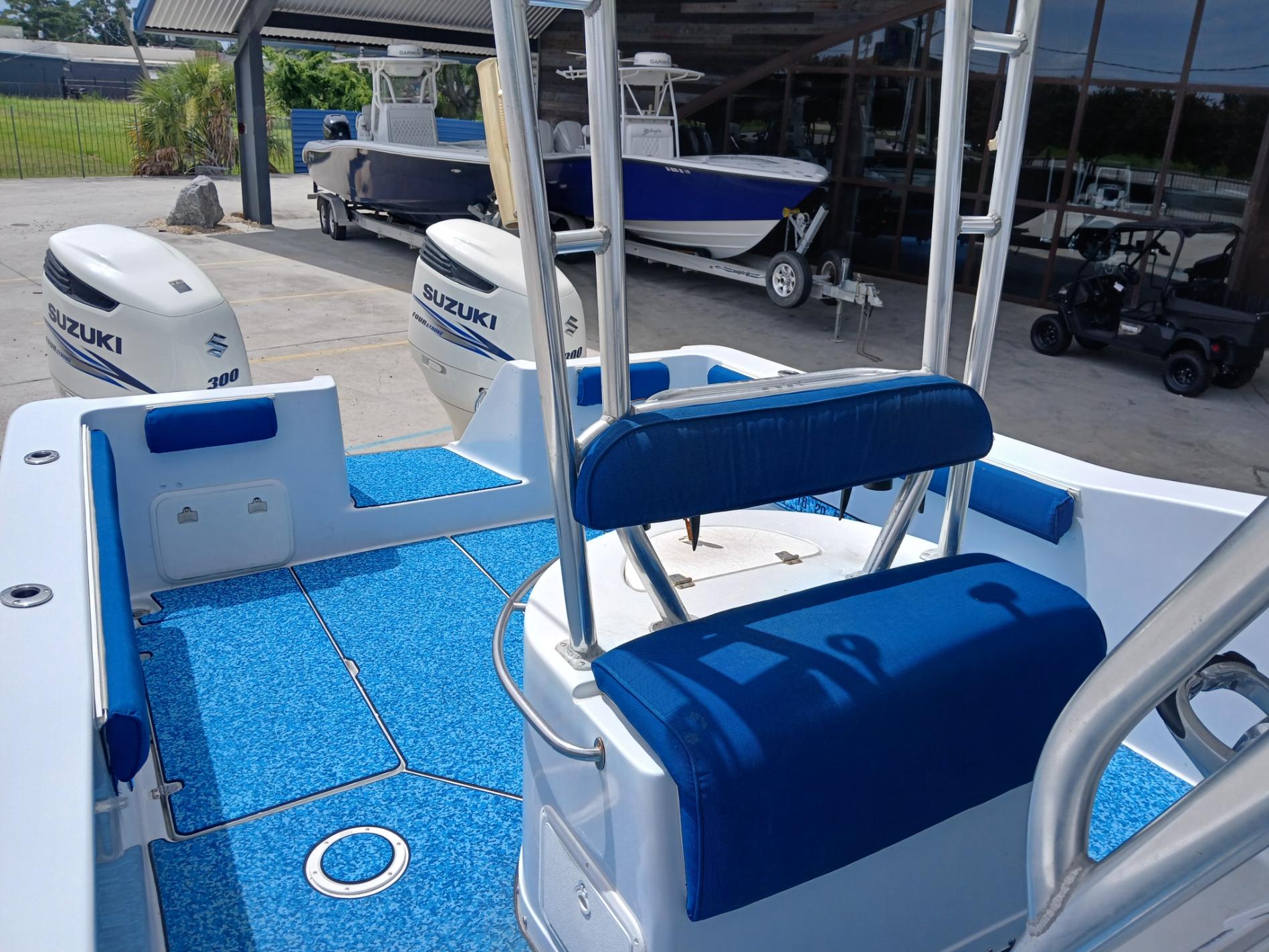 2002 ProKat 2860 Center Console boat with Suzuki engines, blue seating, and deck.