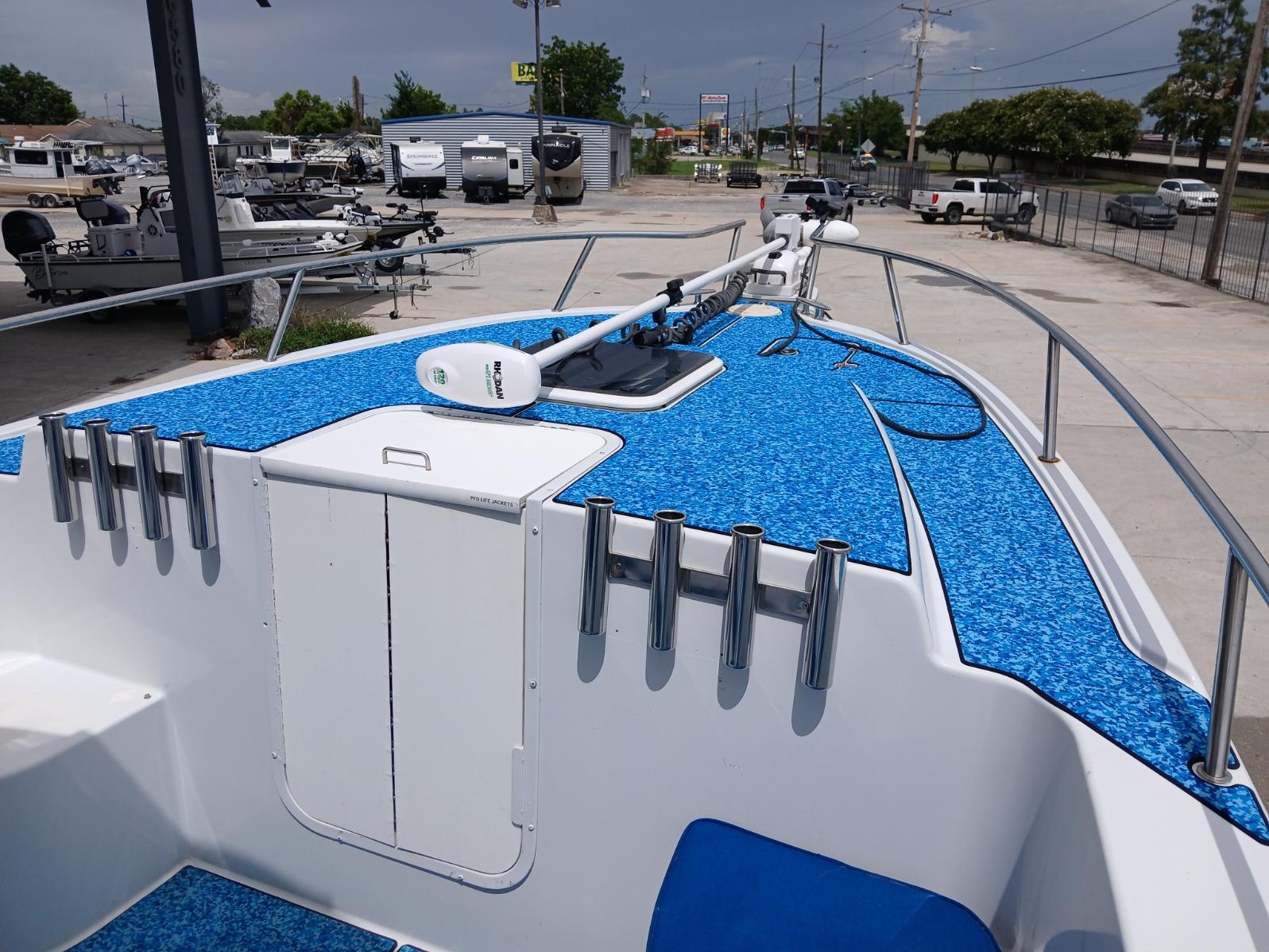 2002 ProKat 2860 Center Console boat with blue deck, docked in a marina.