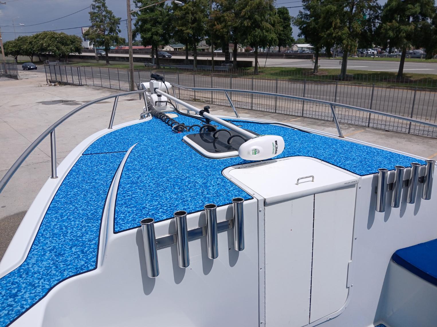2002 ProKat 2860 Center Console boat with blue deck and rod holders.