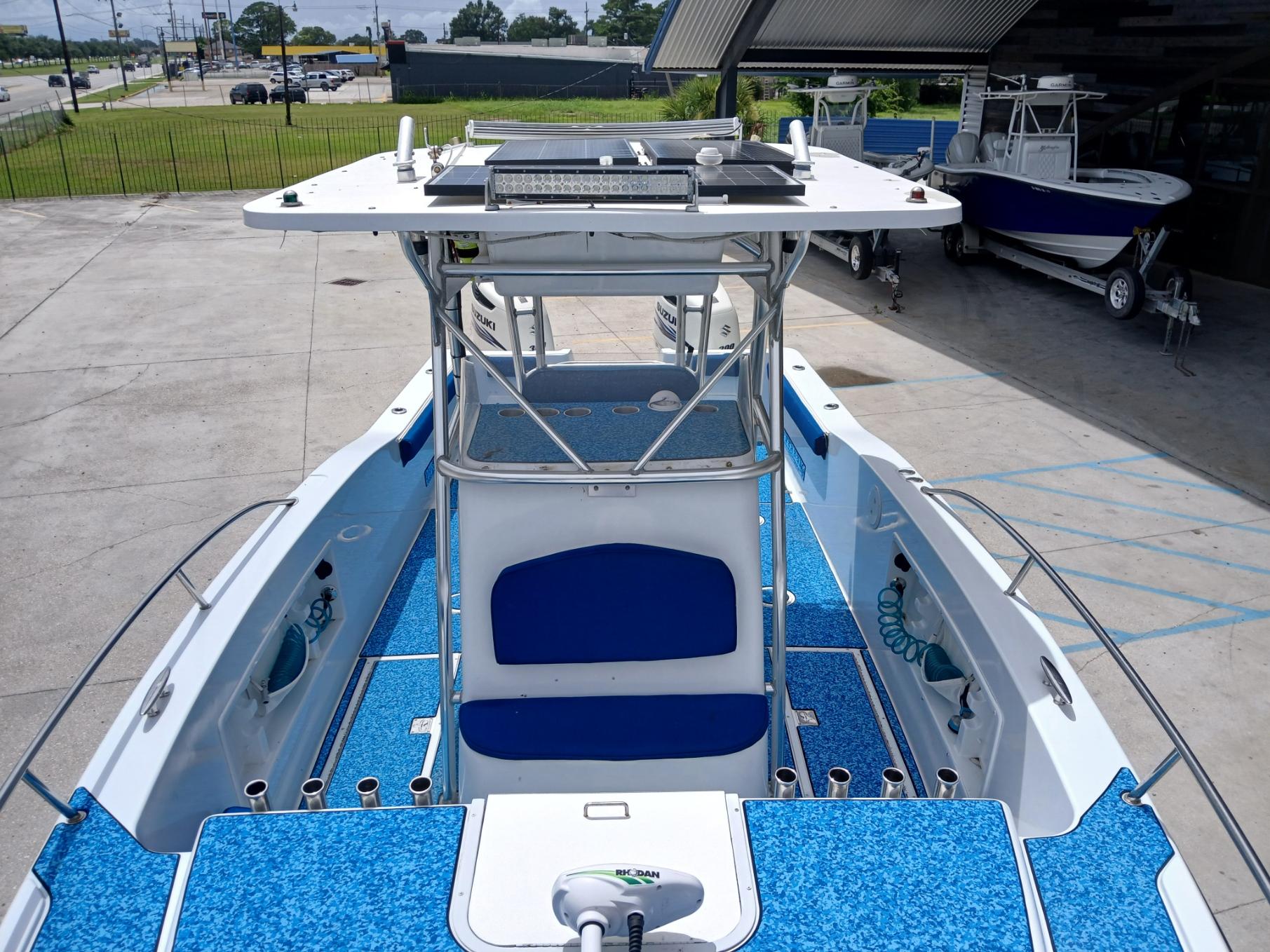 2002 ProKat 2860 Center Console boat with blue deck, docked outdoors.
