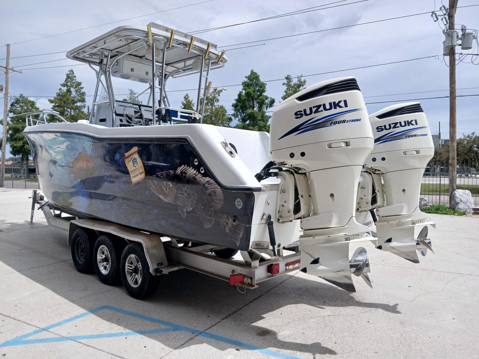 2002 ProKat 2860 Center Console boat with twin Suzuki outboard motors on a trailer.