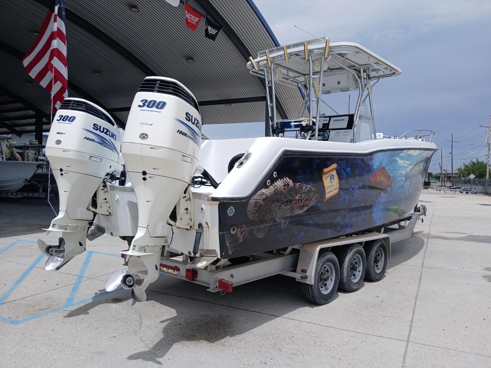 2002 ProKat 2860 Center Console boat with dual Suzuki 300 engines, vibrant marine graphics.