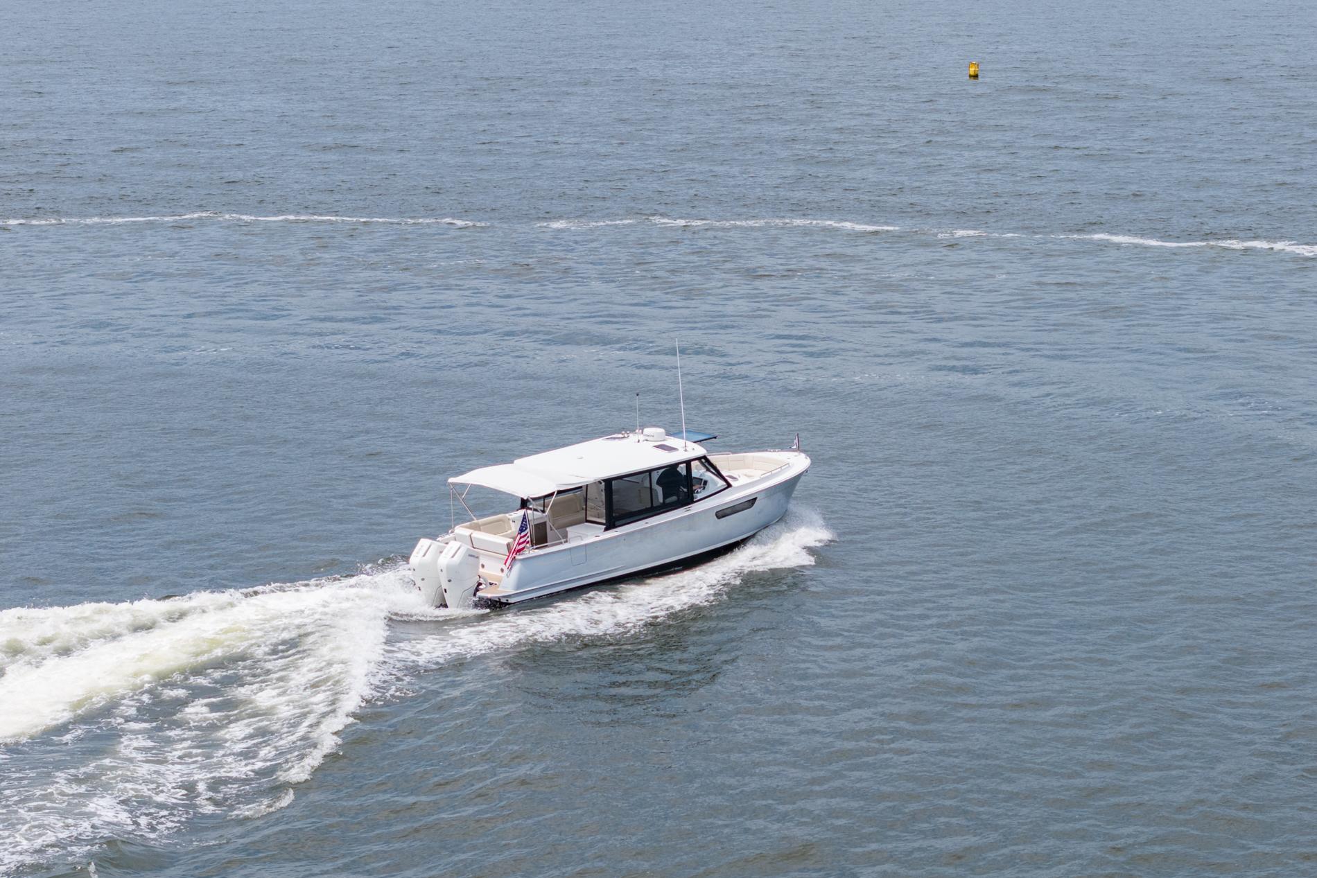 2025 MJM 3 boat cruising on open water, leaving a wake behind.