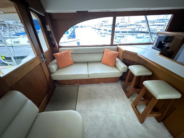 Interior of 1988 Buddy Davis Convertible yacht with beige seating and marina view.