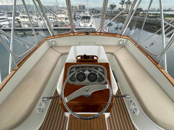 1988 Buddy Davis Convertible yacht helm with wooden dashboard and marina view.