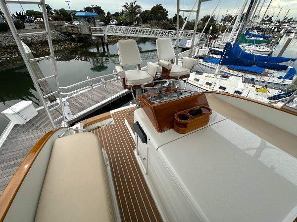 1988 Buddy Davis Convertible yacht with seating and helm, docked at a marina.