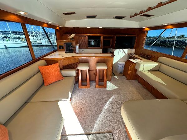 1988 Buddy Davis Convertible yacht interior with beige seating, wooden accents, and marina view.