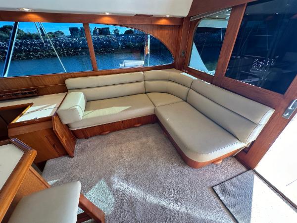Luxurious interior of a 1988 Buddy Davis Convertible yacht with plush seating and large windows.