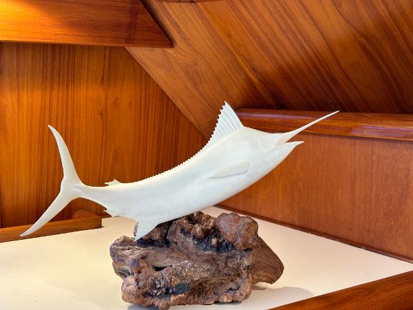 Decorative marlin sculpture on wooden base inside 1988 Buddy Davis Convertible yacht.