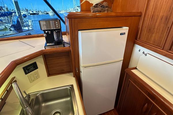 1988 Buddy Davis Convertible yacht kitchen with sink, fridge, and coffee maker.