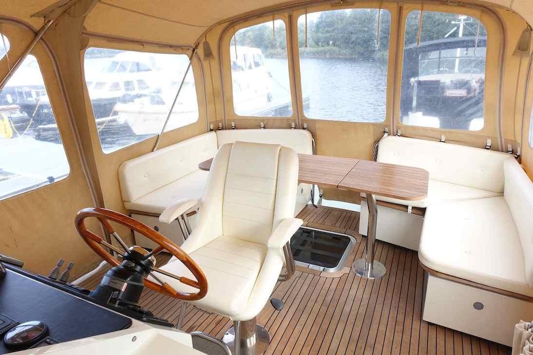Interior of 2014 Linssen Grand Sturdy 40.9 AC yacht with seating and steering wheel.