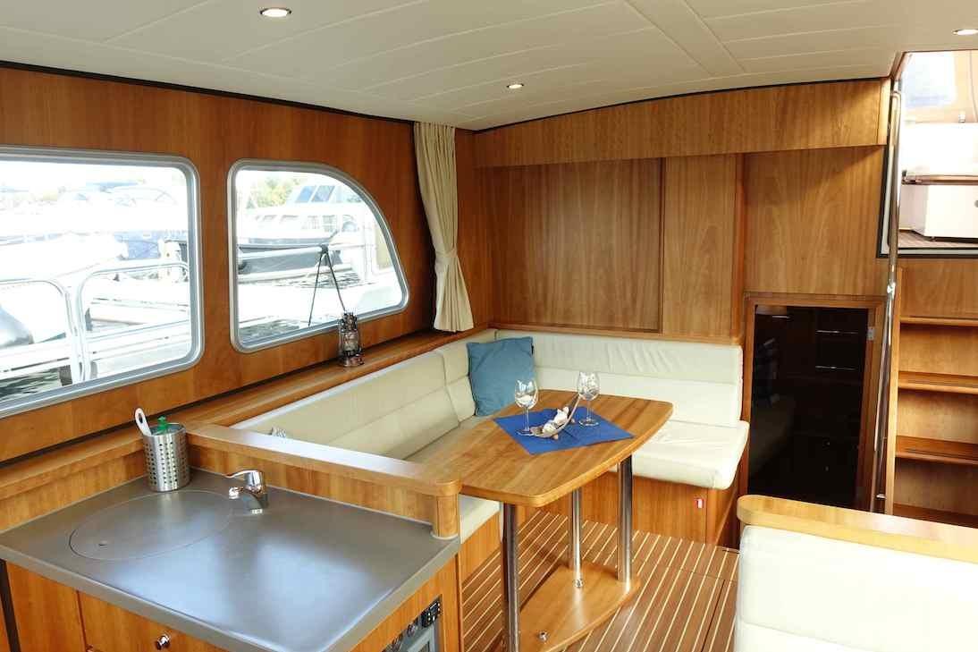 Luxurious interior of 2014 Linssen Grand Sturdy 40.9 AC yacht with wood finish and seating area.