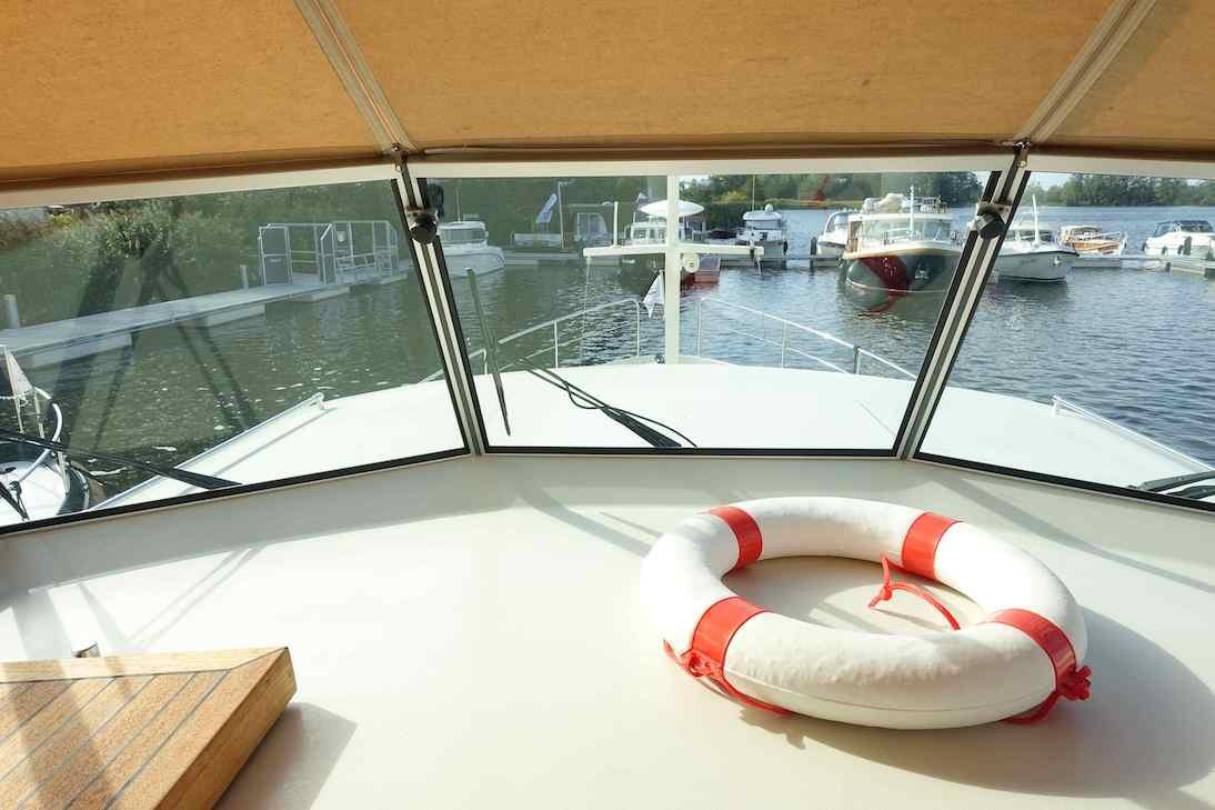 Linssen Grand Sturdy 40.9 AC 2014 yacht interior with life ring, docked at marina.