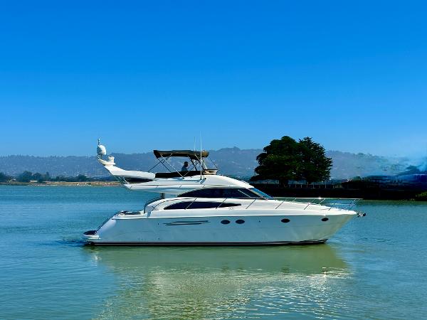2007 Viking Sport Cruiser yacht on calm water under clear blue sky.