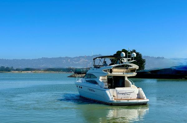 2007 Viking Sport Cruiser yacht on calm water under clear blue sky.