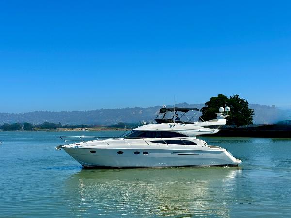 2007 Viking Sport Cruiser yacht on calm water under clear blue sky.