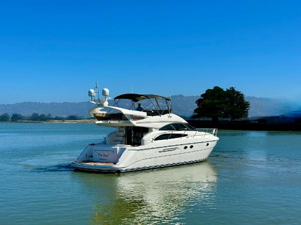 2007 Viking Sport Cruiser yacht on calm water under clear blue sky.