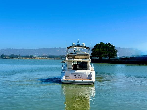 2007 Viking Sport Cruiser on calm water under clear blue sky.