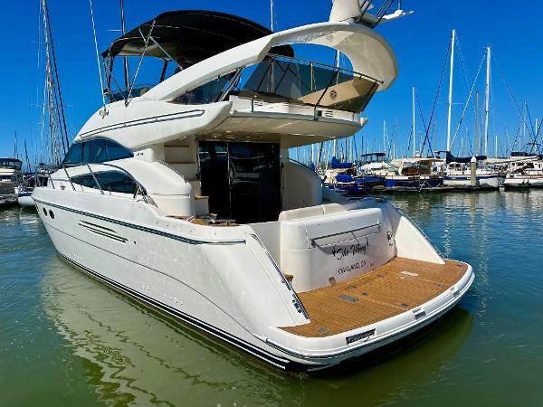 Luxury 2007 Viking Sport Cruiser yacht docked in marina under clear blue sky.
