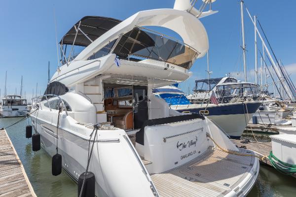 2007 Viking Sport Cruiser yacht docked at marina, featuring sleek design and spacious deck.