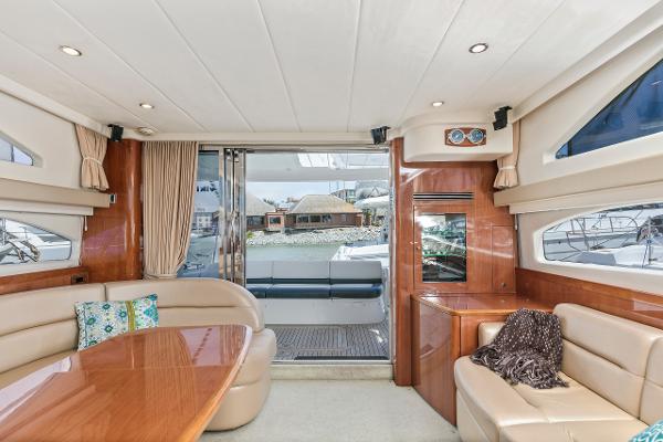 Luxurious interior of 2007 Viking Sport Cruiser yacht with elegant seating and wooden finishes.