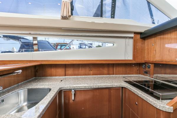 Interior of 2007 Viking Sport Cruiser kitchen with wood cabinetry and modern appliances.