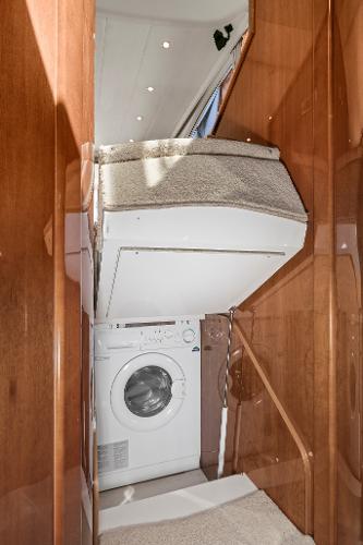 2007 Viking Sport Cruiser interior with washing machine and wooden cabinetry.