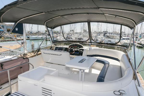 2007 Viking Sport Cruiser yacht interior with helm, seating, and marina view.