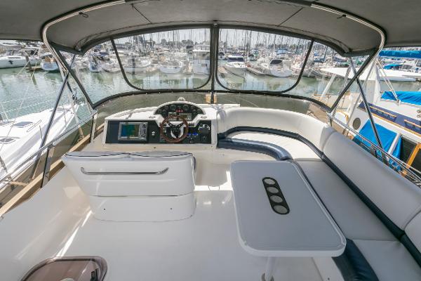 2007 Viking Sport Cruiser helm with marina view, featuring seating and navigation controls.
