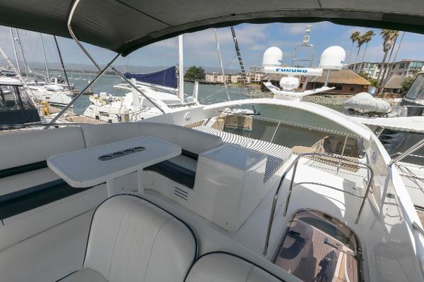 2007 Viking Sport Cruiser yacht interior with seating and table, docked at marina.