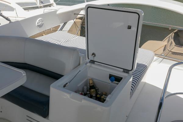 2007 Viking Sport Cruiser with open cooler, stocked with beverages, on deck seating area.