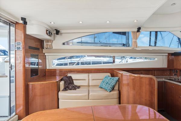 Luxurious interior of 2007 Viking Sport Cruiser yacht with plush seating and elegant wood finishes.
