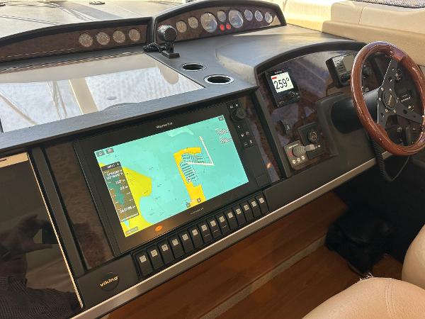 2007 Viking Sport Cruiser dashboard with navigation display and wooden steering wheel.