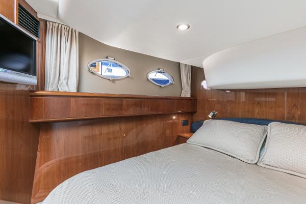 Luxurious cabin interior of a 2007 Viking Sport Cruiser yacht with elegant wood finish.