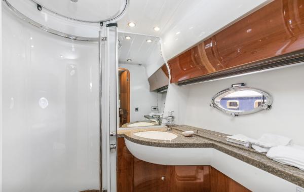 Luxurious bathroom in 2007 Viking Sport Cruiser with modern fixtures and elegant wood accents.