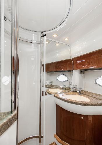 Luxurious bathroom in 2007 Viking Sport Cruiser with modern fixtures and elegant wood accents.