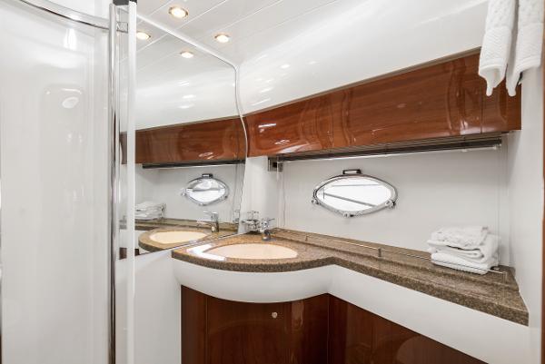 Luxurious bathroom in 2007 Viking Sport Cruiser with elegant wood and modern fixtures.
