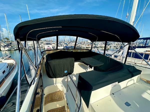 2007 Viking Sport Cruiser with covered deck, docked in a marina under clear blue skies.