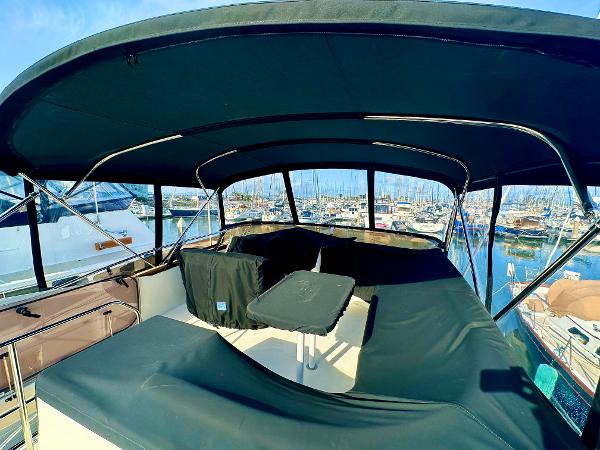 2007 Viking Sport Cruiser with covered deck, docked at marina.