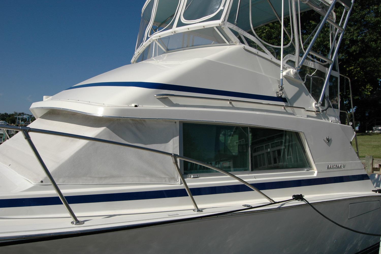 1987 Bertram 33 Sport Fisherman boat with sleek design and blue accents.