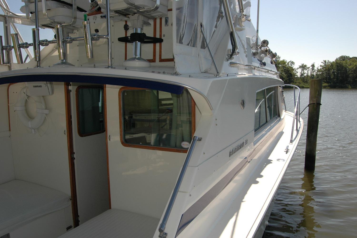 1987 Bertram 33 Sport Fisherman boat docked by the water, showcasing its sleek design.