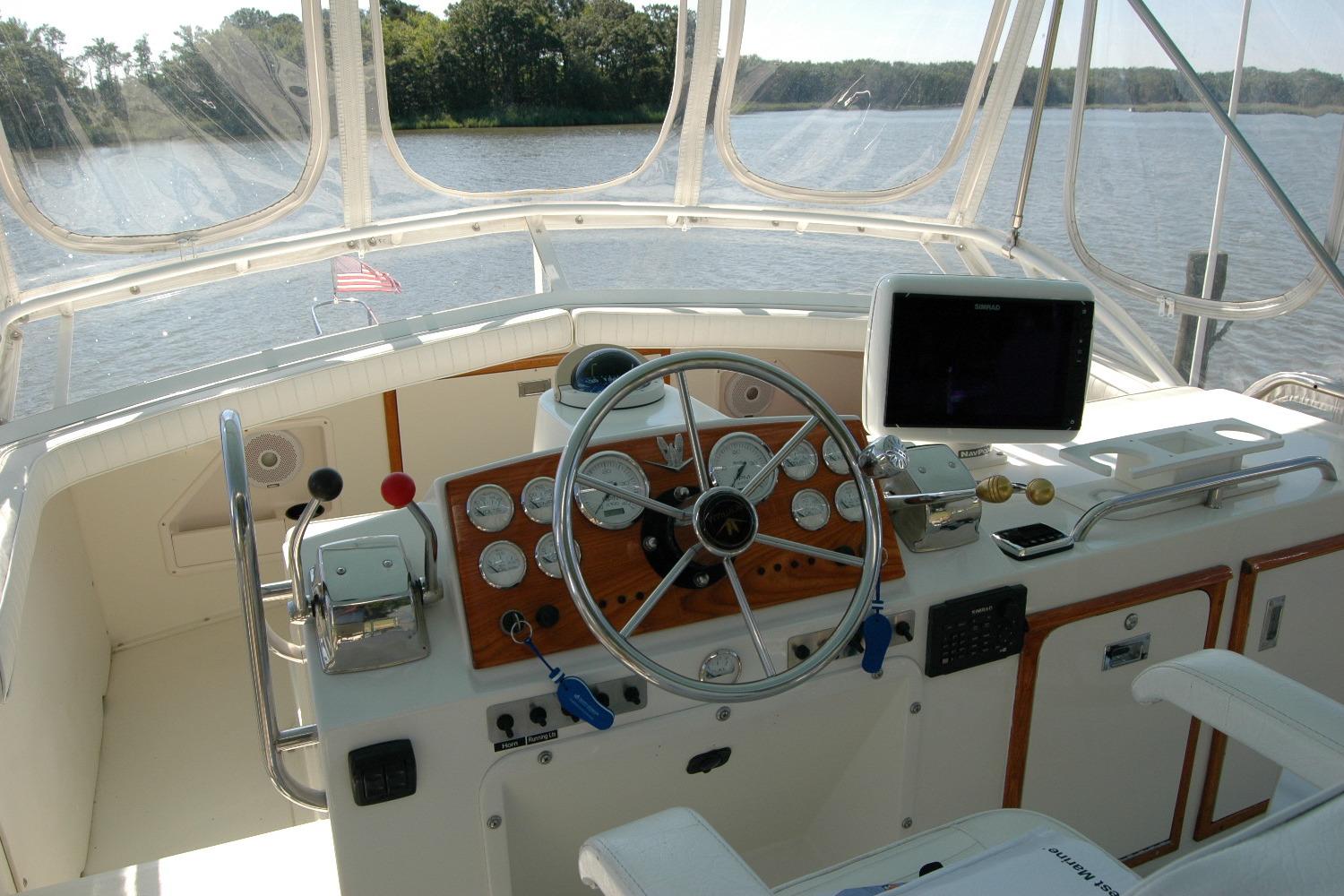 1987 Bertram 33 Sport Fisherman helm with steering wheel, gauges, and navigation equipment.