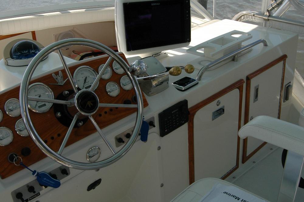 1987 Bertram 33 Sport Fisherman helm with steering wheel and navigation instruments.