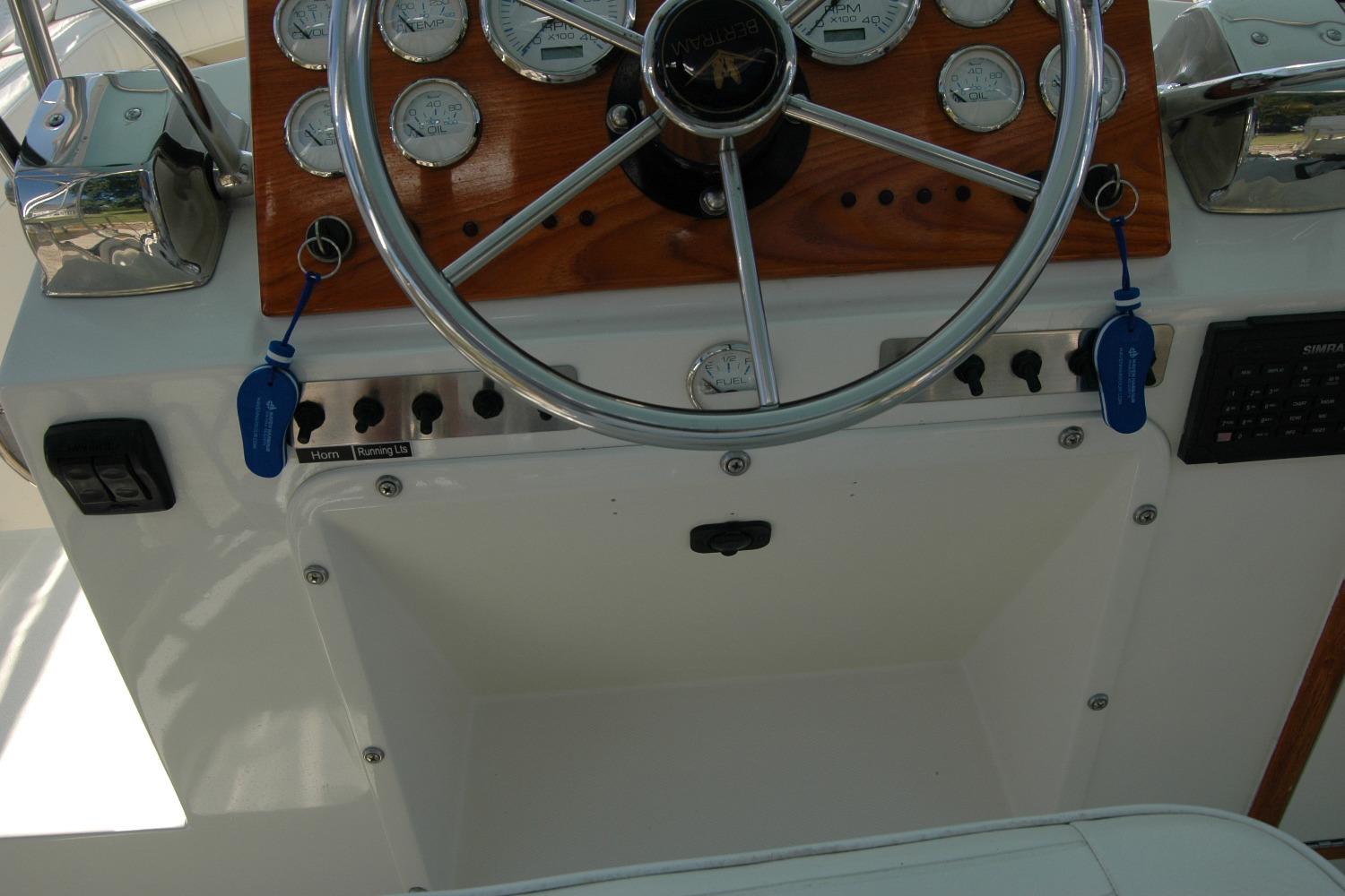 1987 Bertram 33 Sport Fisherman helm with gauges, steering wheel, and control panel.