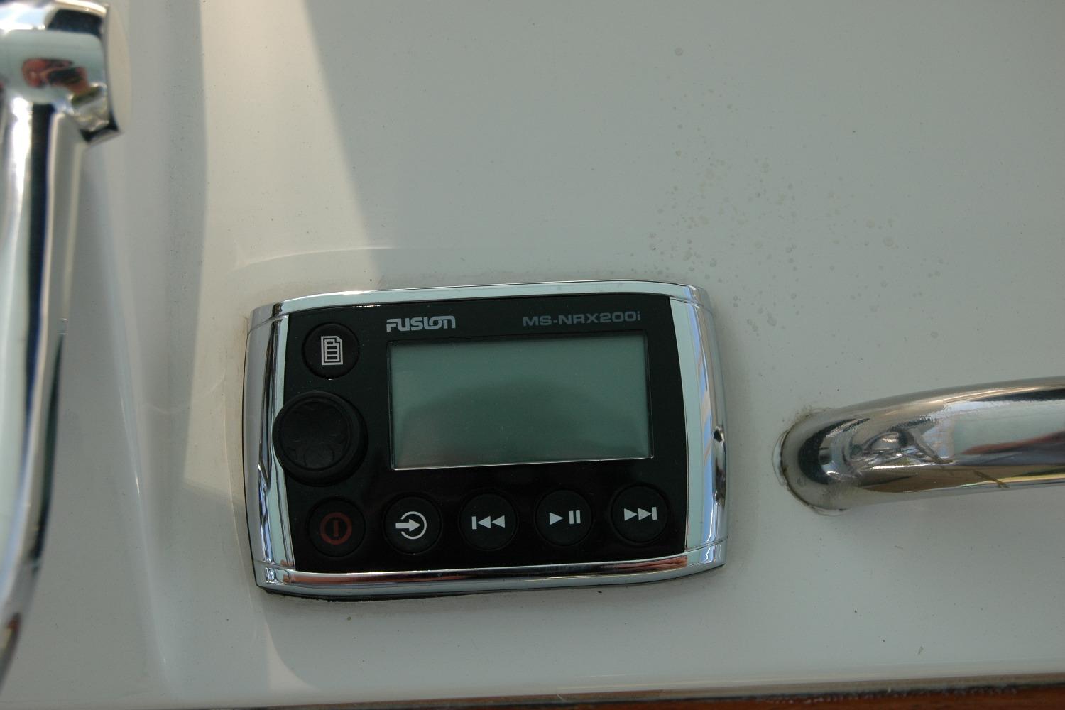 Fusion MS-NRX200i marine stereo on 1987 Bertram 33 Sport Fisherman boat dashboard.