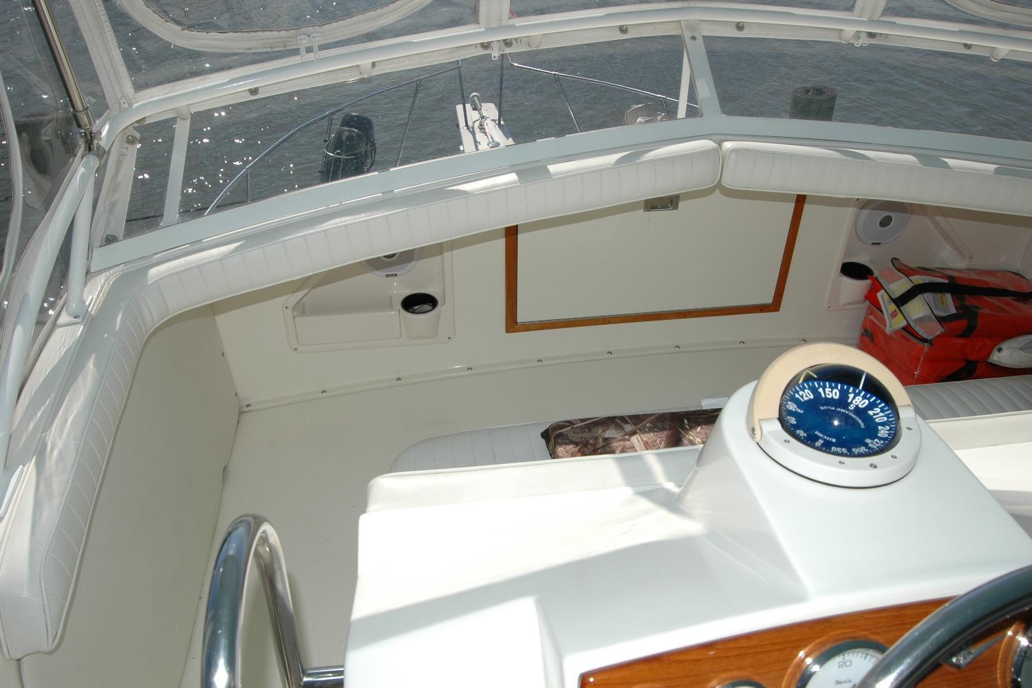 1987 Bertram 33 Sport Fisherman cockpit with compass and seating area.