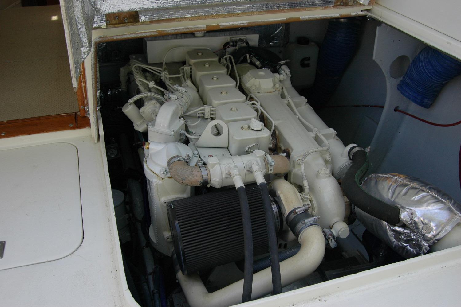 Engine compartment of a 1987 Bertram 33 Sport Fisherman boat, showcasing detailed machinery.