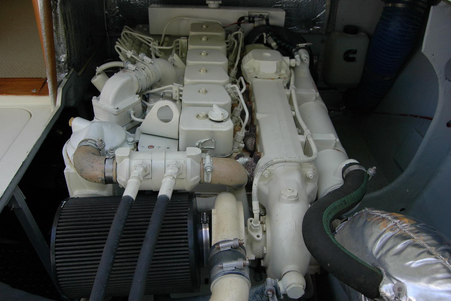 Engine compartment of a 1987 Bertram 33 Sport Fisherman boat, showcasing detailed components.