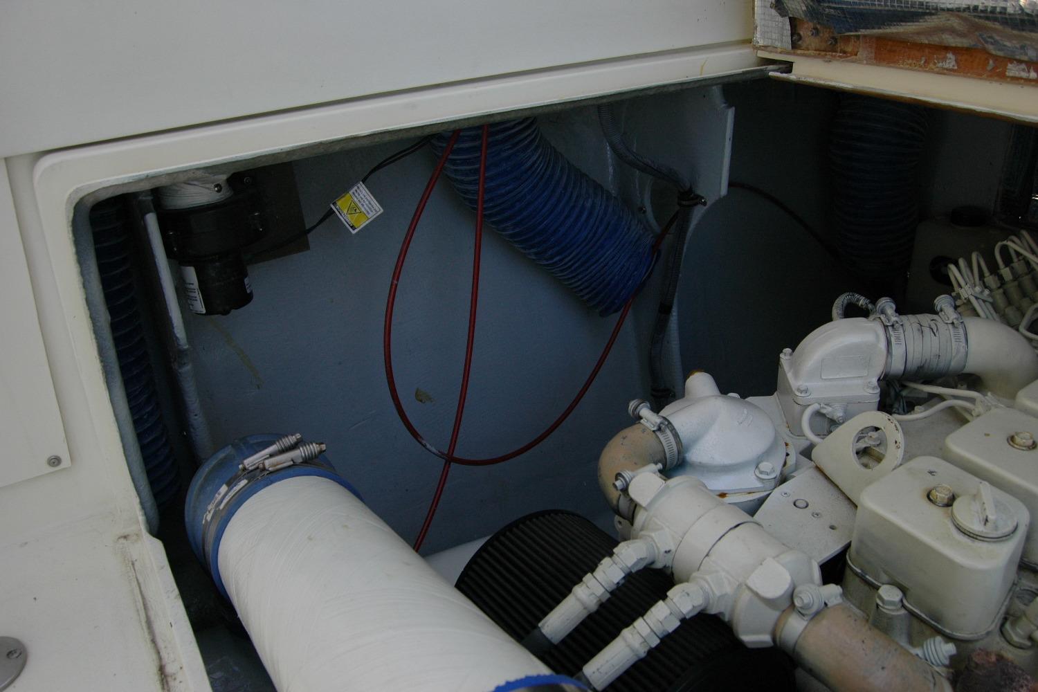 Engine compartment of a 1987 Bertram 33 Sport Fisherman boat, showing mechanical components.
