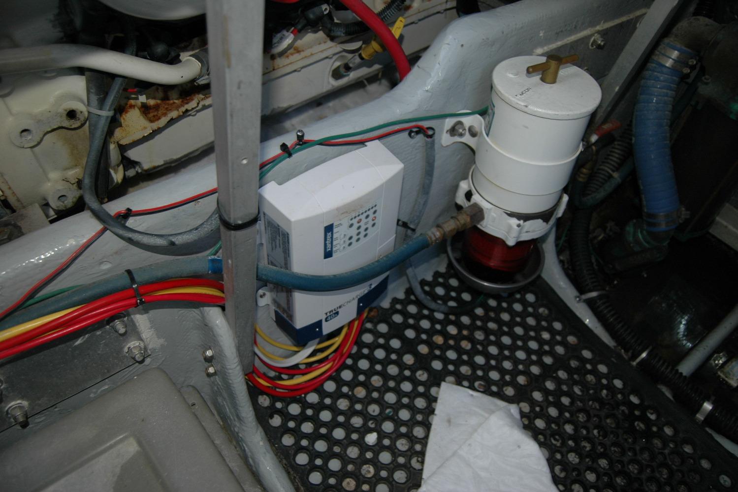 Engine room of 1987 Bertram 33 Sport Fisherman with wiring and filter system.